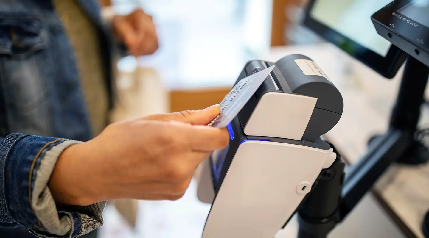 A person using their S&T Bank card to pay for something using the touchless feature.